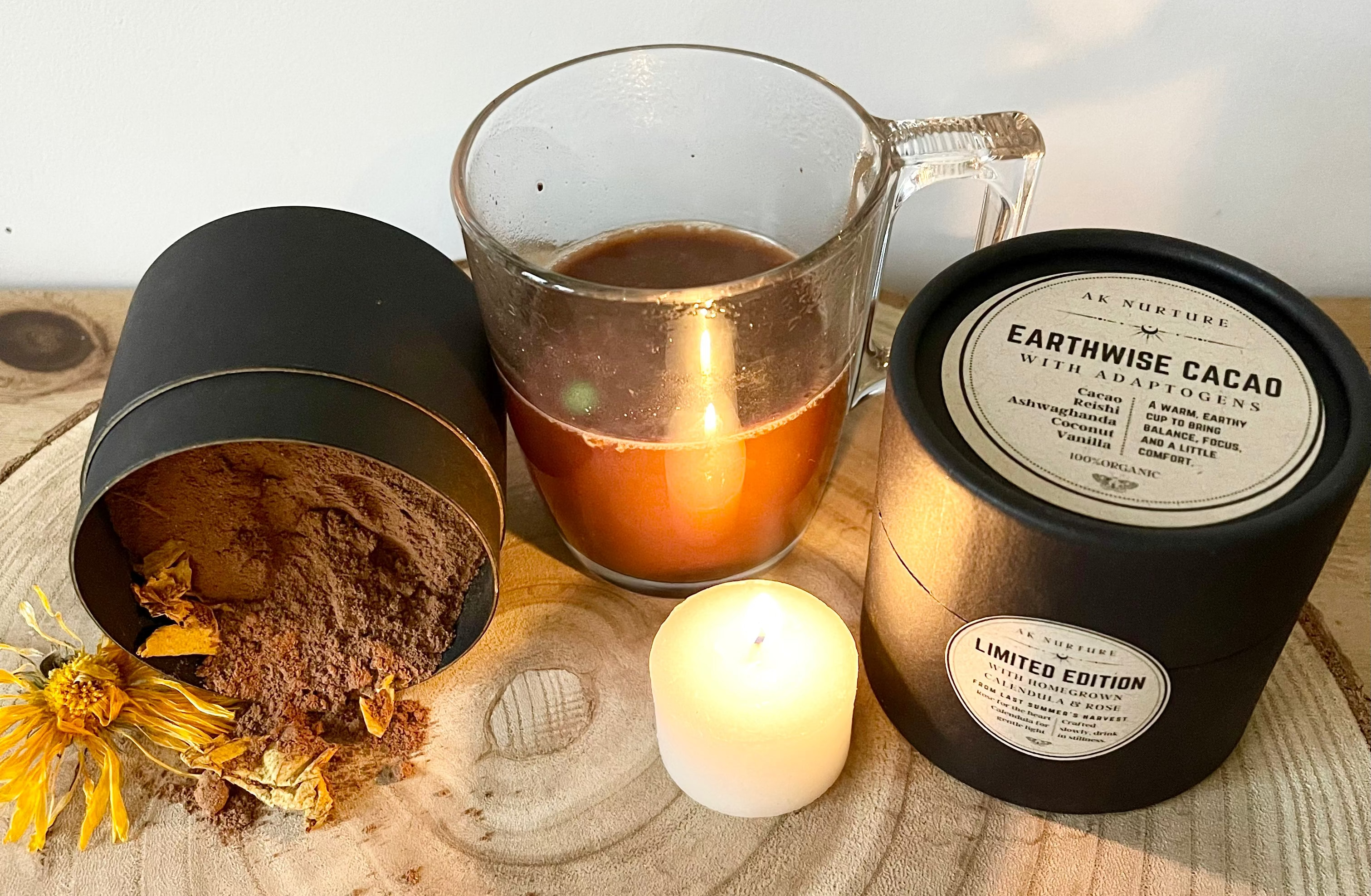 Cup of cacao, candle, and Earthwise Cacao product on a wooden surface with 'Earthwise' branding.